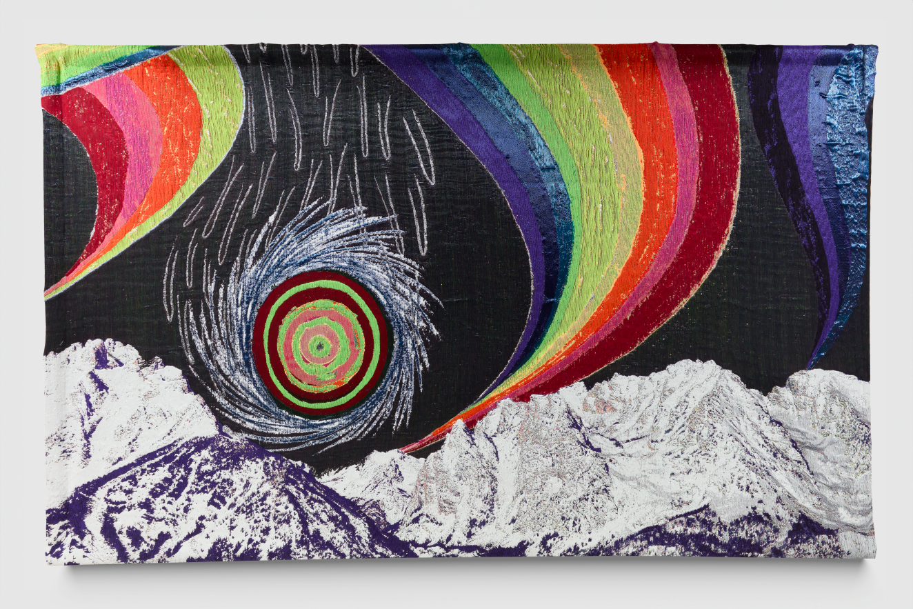 A vibrant textile artwork with a glowing spiral against a dark sky surrounded by large rainbows swooping down to large snow-covered mountains stretch below.