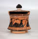 A small, flared, terracotta container with a black-glazed lid, adorned with black figures in flowing robes, holding instruments.