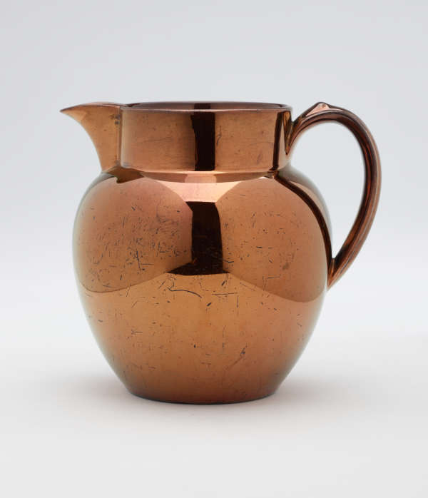 A bronze-colored jug.
