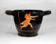 Rounded black vessel with thick handles and a cracked surface featuring orange illustrations of a partially nude figure wearing draped fabric besides a tall horizontal arrow  running with arms outstretched.