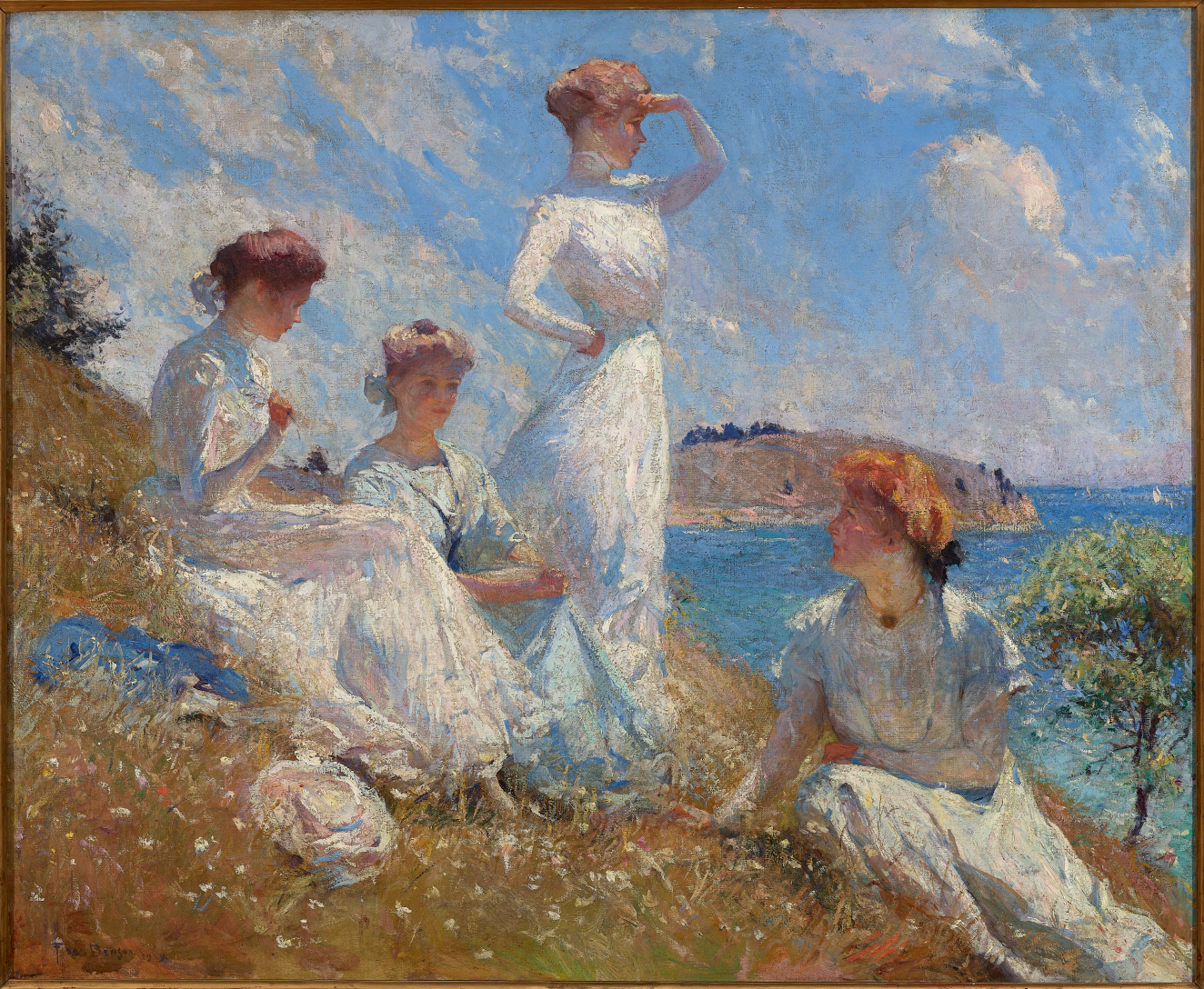 Four women in flowing white dresses relaxing on a sunlight grassy slope, enjoying the breeze and bright blue sky.