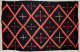 Striped navy blue blanket with three, different sized, alternating cross patterns: red crosses, red with white tips, and white with red tips, within a red and cream three-striped diamond pattern.