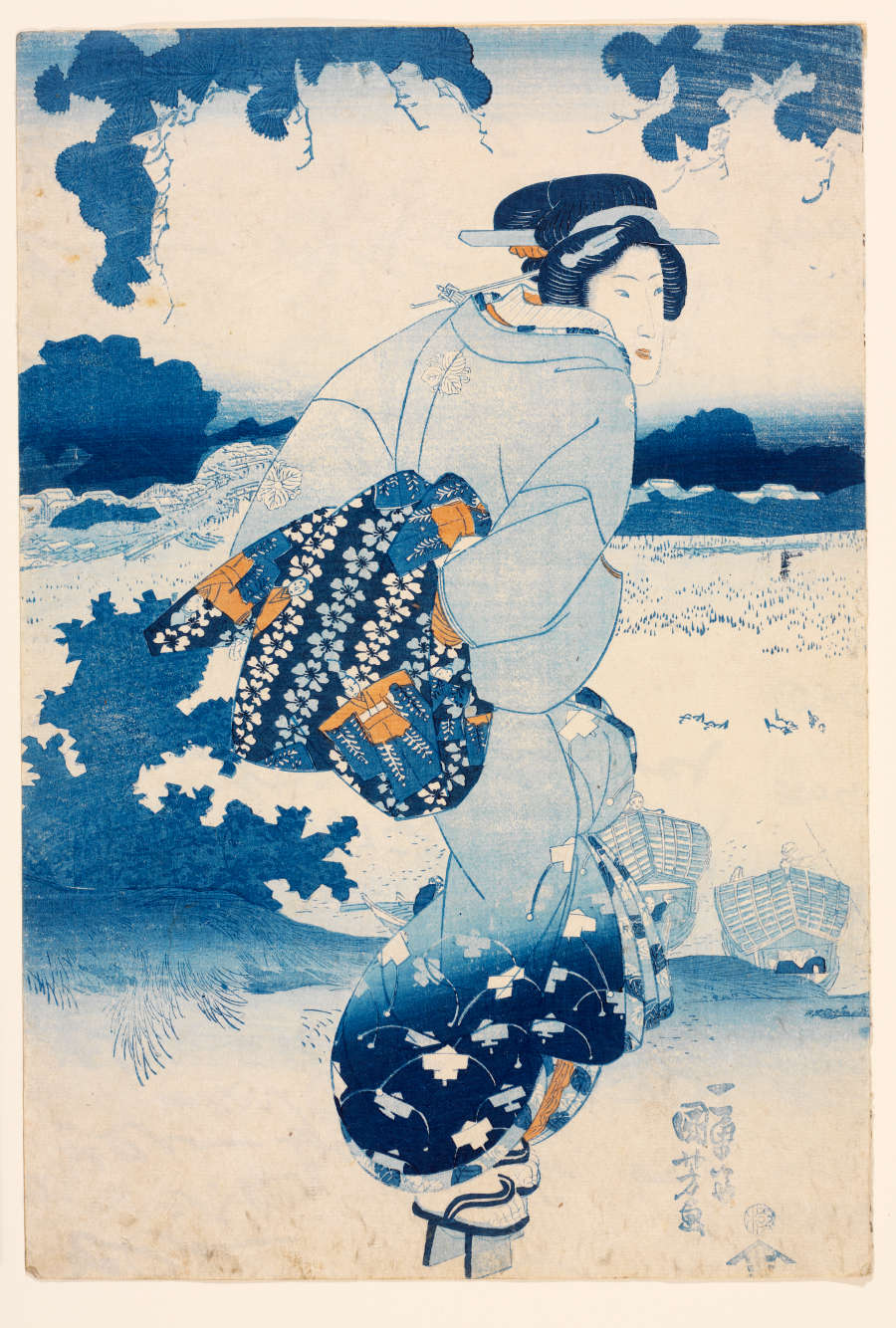 Japanese woodblock print of a woman in a blue kimono holding a patterned fabric behind her back. She is looking over her shoulder against a monochrome backdrop of blue clouds and landscapes.