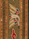 Close-up of embroidered white and gold bird with long, curved neck, framed by red flames, gold vertical bands, and geometric borders set against a gold and green latticework background. 