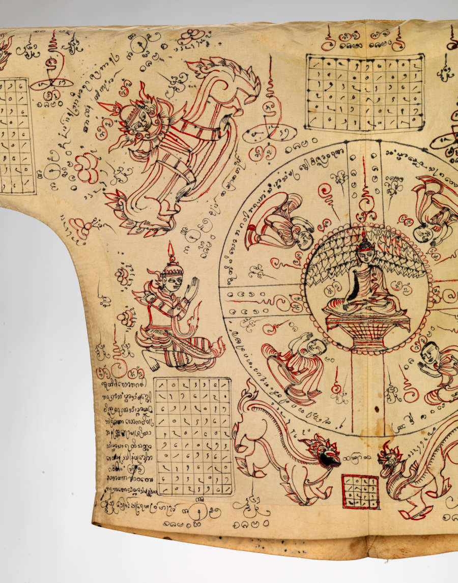 Detail-view of the shirt’s back with a circular diagram with a seated figure at the center. Various grids, organic lines, and illustrations of people and animals surround it.