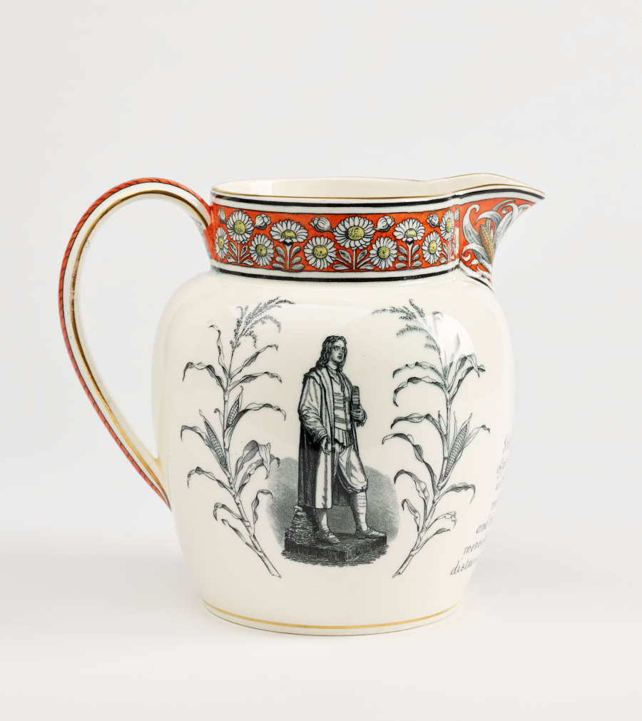 A jug with a band of red, yellow, and black daisy decorations at the top. A prominent gray tone figure and flora on the body of the vessel.