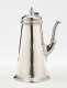 A silver chocolate pot with a spout, hinged lid, and fruitwood handle that is 90 degrees from the spout.
