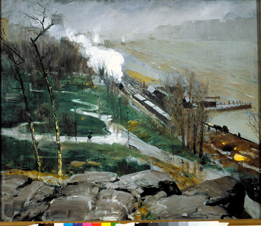 Misty, overcast scene with a steam train trailing white smoke as it passes between a damp green parkland with a winding footpath and a clouded, turbulent river.