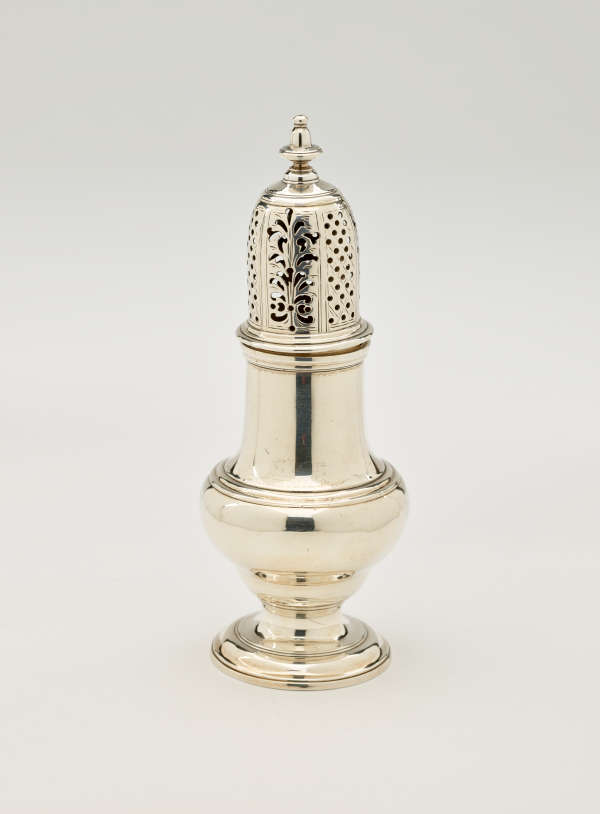  A silver vessel with a foot, rounded body that goes to a cylindrical top half, and the lid is perforated with small holes and floral cutouts.