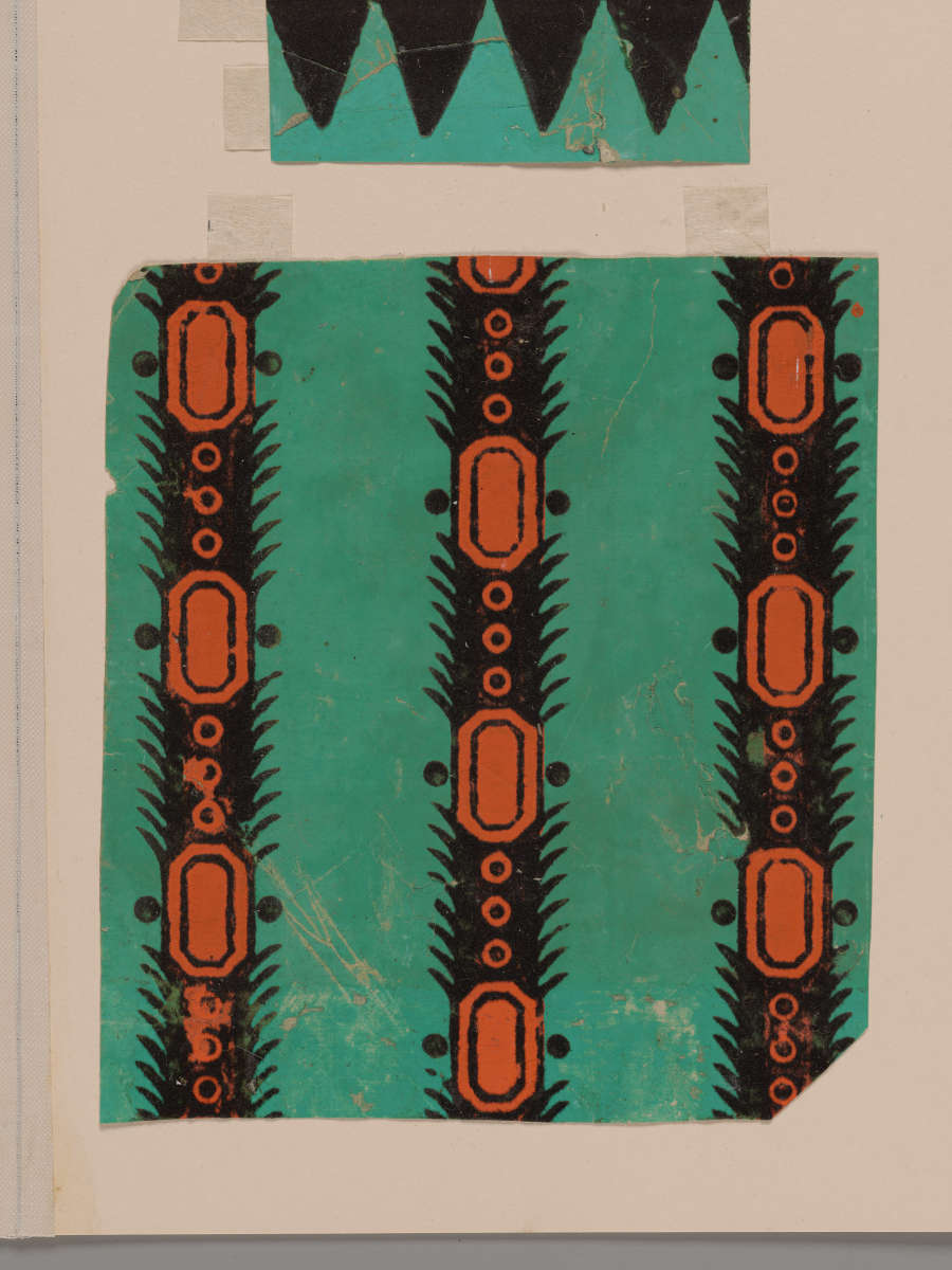 Square fragment with vertical black and orange ovals and circles, set against a bright teal backdrop, with scuffs towards the bottom. Displayed under a border fragment on a beige background.