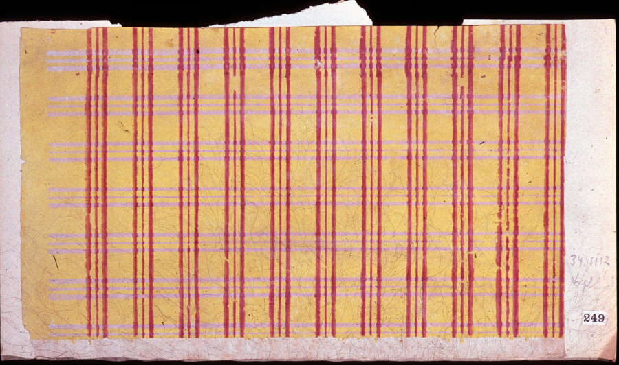 Tan, striped wallpaper with jagged edges, a white sticker with “249” in black text, handwritten text that reads “34.1112 dye,” and three red lines repeated vertically, and multiple yellow lines repeated horizontally.
