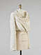 A cream colored, draped garment with wide sleeves and gold-accented scallop designs, fitted on a mannequin torso.