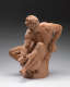 Realistically carved terracotta sculpture depicting a muscular bearded man facing left, sitting and leaning over a vessel he’s holding between his legs while keeping his body in tension.