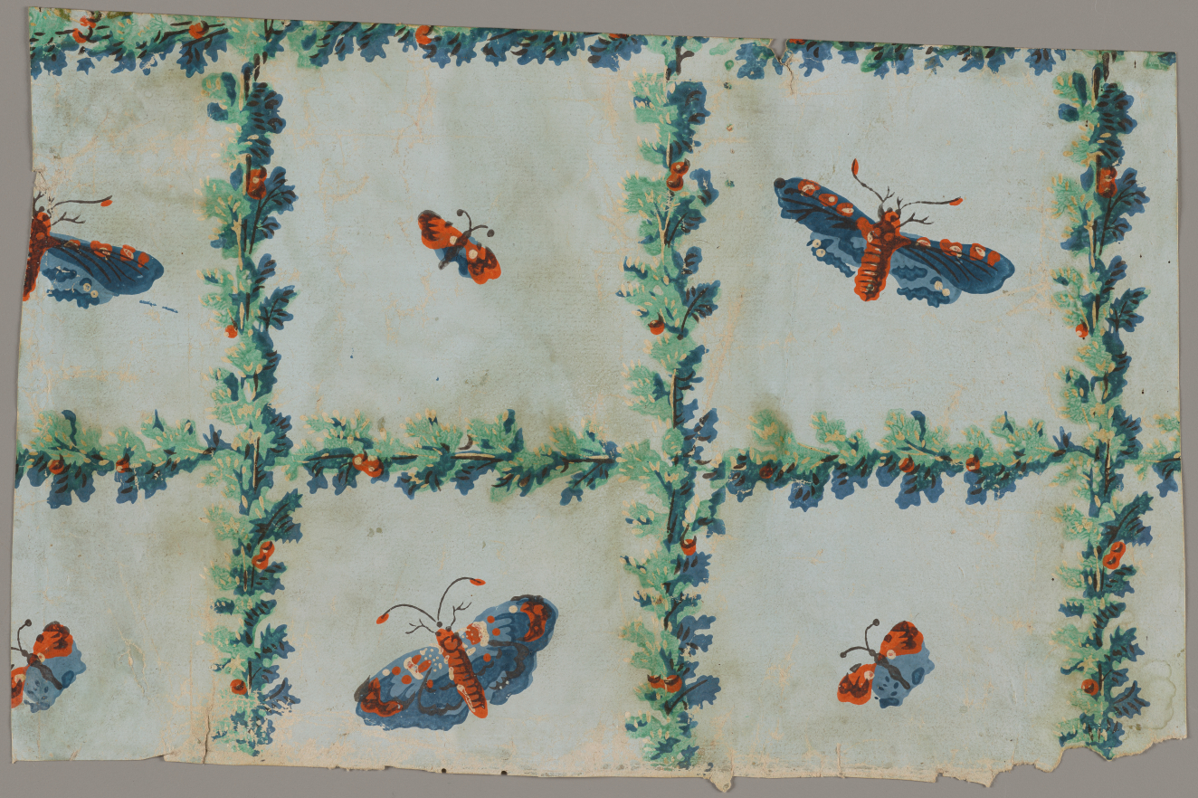 Light blue, blemished wallpaper with various sized orange and blue butterflies in the center of a grid made out of intersecting green garlands with red berries