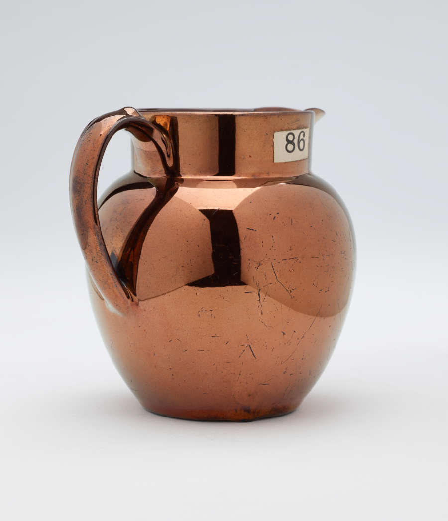 A bronze-colored jug.
