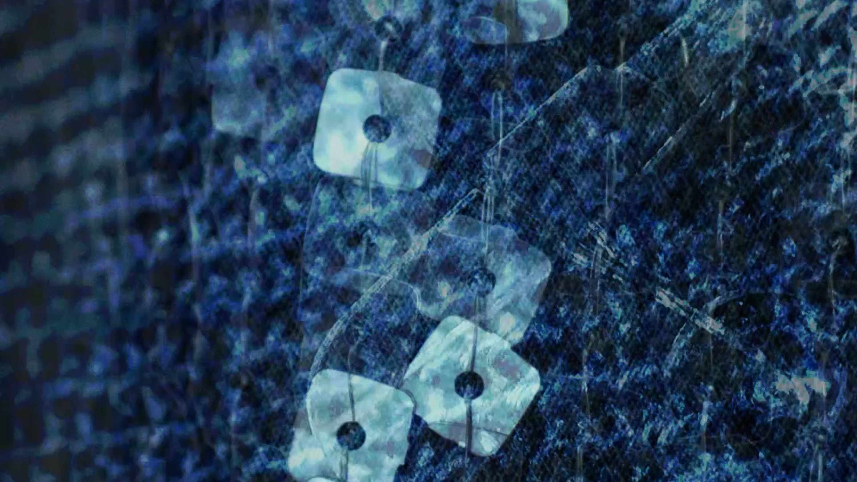 A dark abstract photograph of blue and black tones with light blue and translucent squares run through the center. The squares appear to be stitched to the background through holes in their centers.