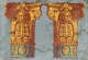 Wallpaper fragment featuring two vivid golden-yellow Corinthian columns adorned with lion heads, acanthus leaves, and florals with a teal stripe lining the base. The backdrop is gray and water stained.