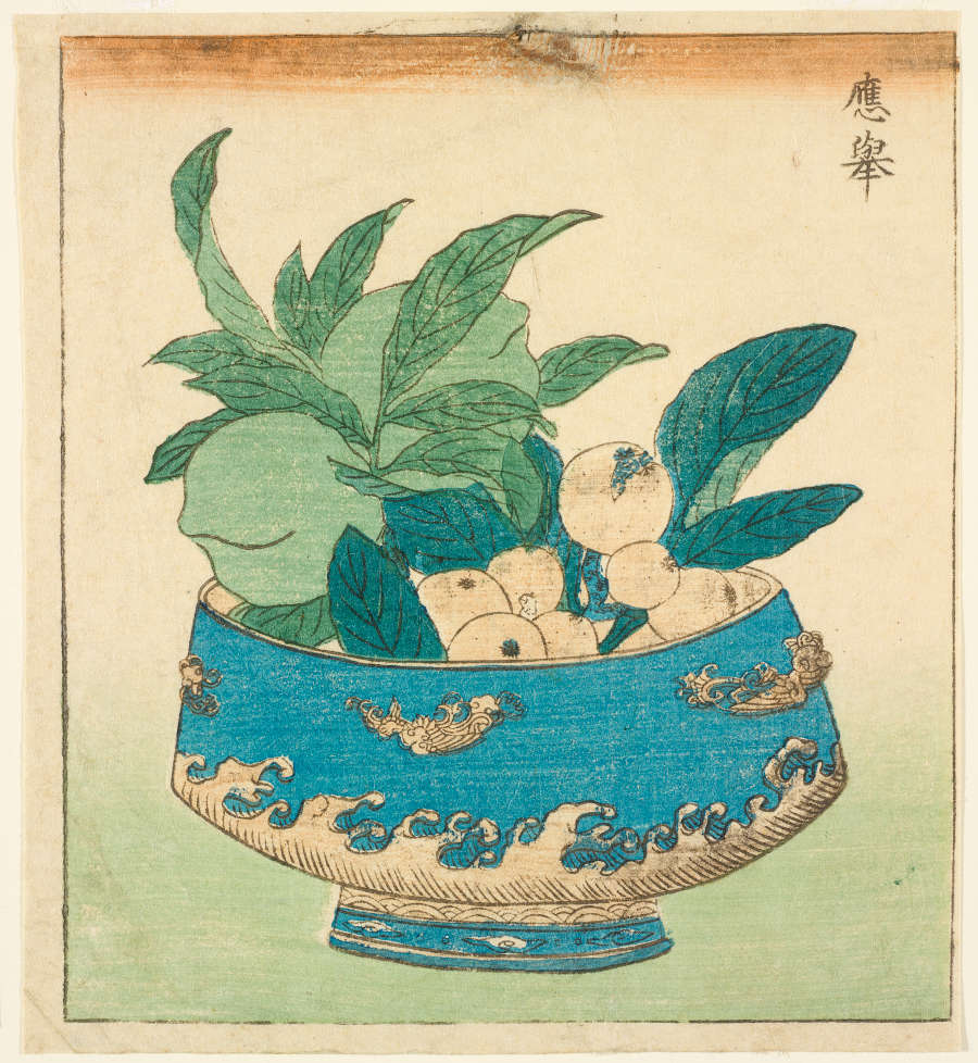 Woodblock print of an arrangement of large green fruits and smaller pale fruits balanced by broad leaves in a blue porcelain bowl with white wave-like ornaments at its base.