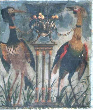 Ripped and weathered, cream painting of two large multicolored birds chained by the neck to a metal, fruit filled, vase on top of a three-legged pedestal.