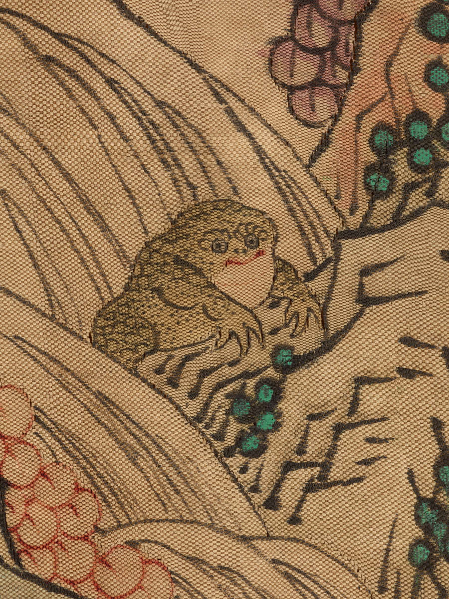 Detail of the scroll showing a spotted frog amongst flowers and leaves.