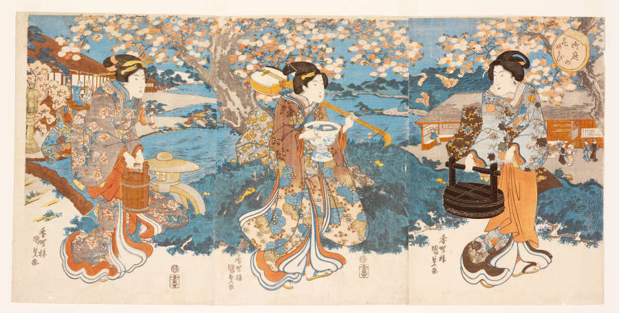 Vibrant three-part woodblock print of three women on a garden outing, framed by cherry blossoms. They wear floral-patterned robes and carry food boxes, drinking vessels, and a musical instrument.
