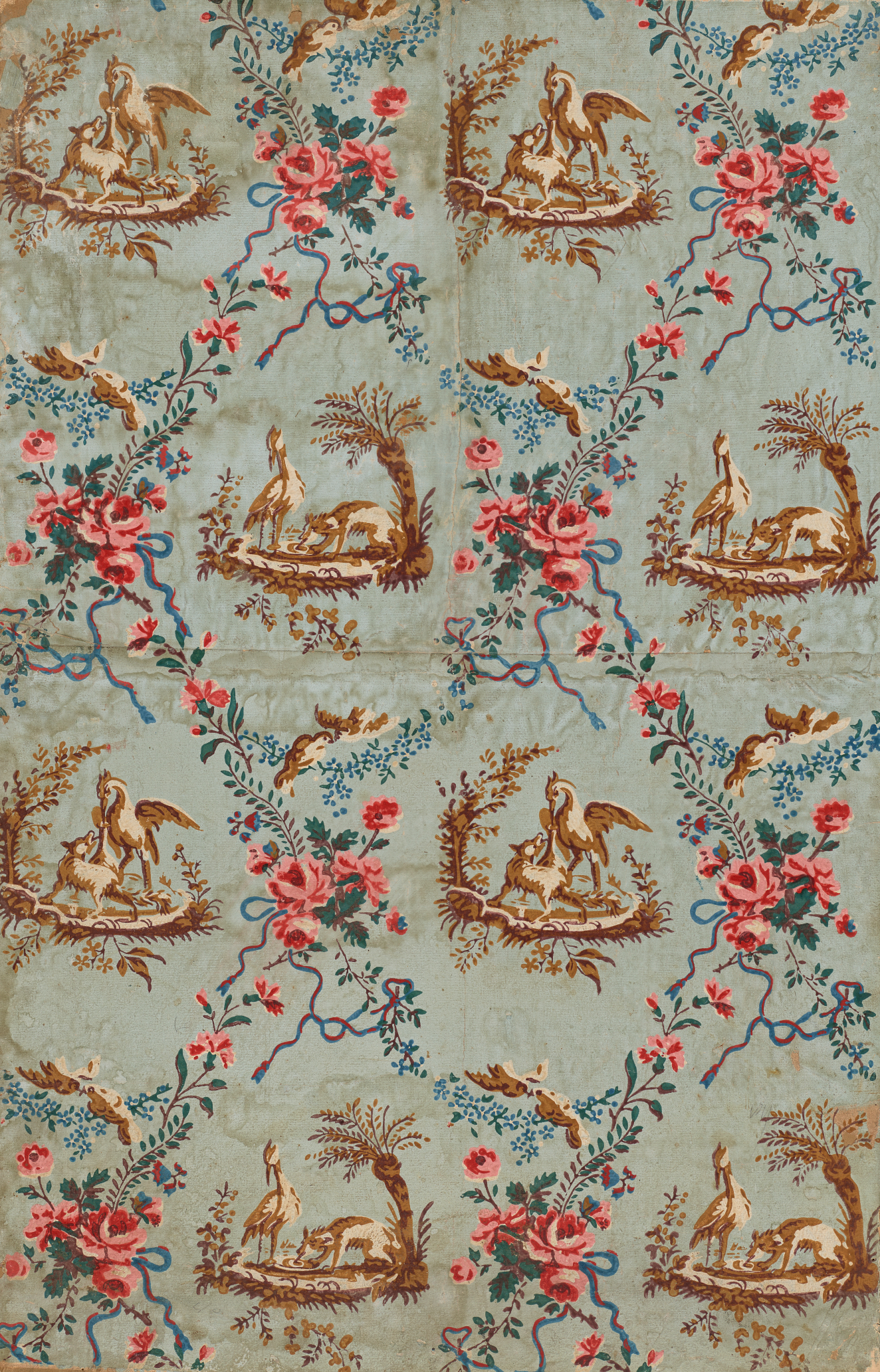 Segment of vintage wallpaper featuring a pattern of repeating brown illustrations of wildlife in nature, surrounded by vibrant, decorative floral chains and foliage motifs; set on a faded blue background.