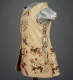 Side of a cream colored bodice with ties running up the sides and under the arms embroidered front to back with colorful depictions of soaring birds and delicate foliage.