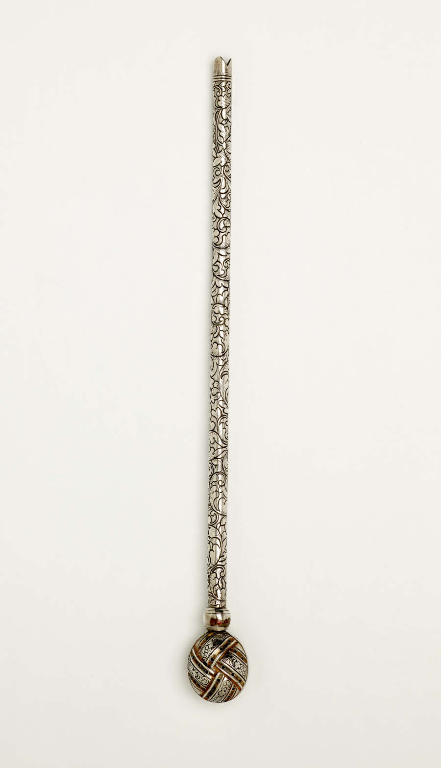  A long silver utensil with a decorative body and has one small bulbous end.