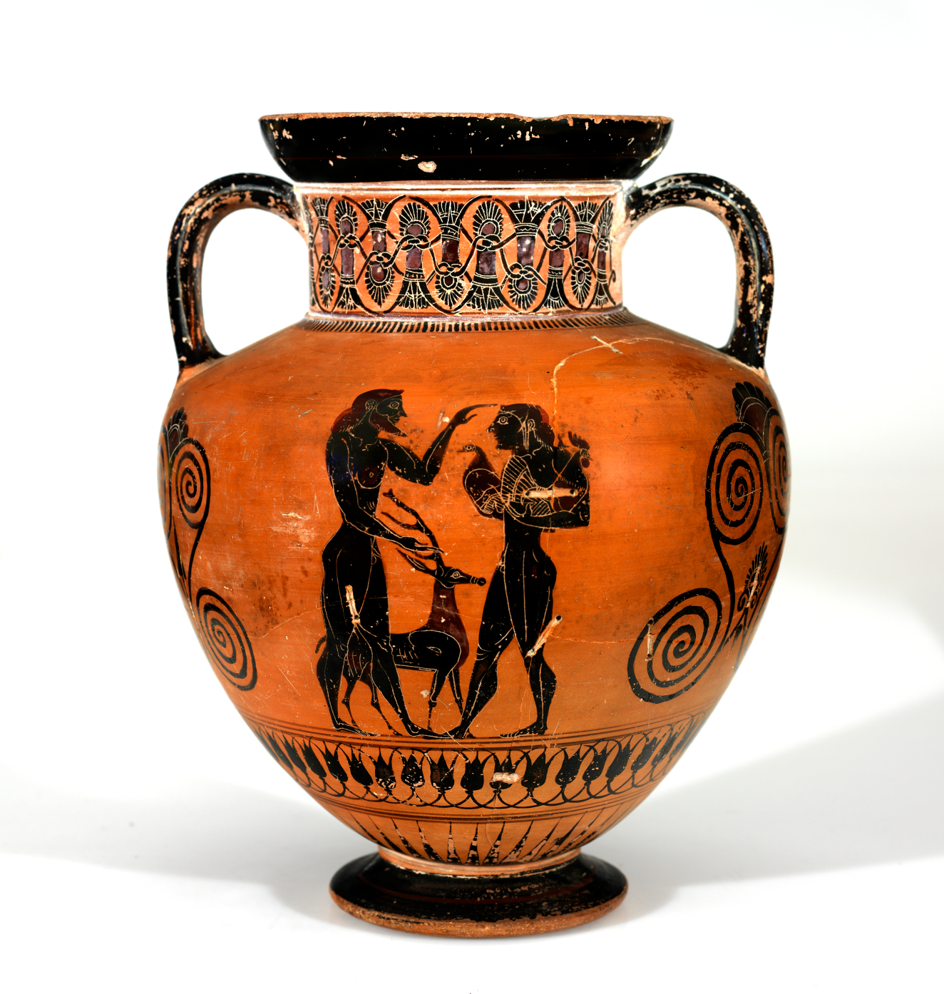 A terracotta vessel with two black figures with a dog, framed by spirals and intricate floral motifs.