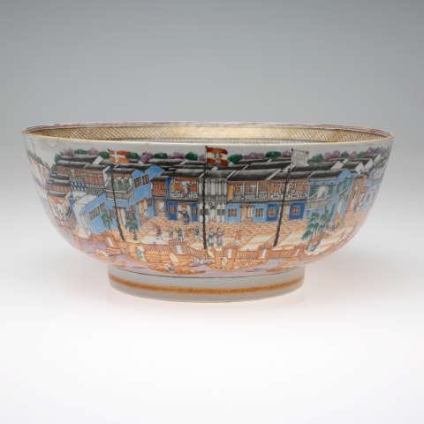 An intricately painted ceramic bowl with a bustling city scene, featuring colorful buildings, trees and figures, and including a gold rim.