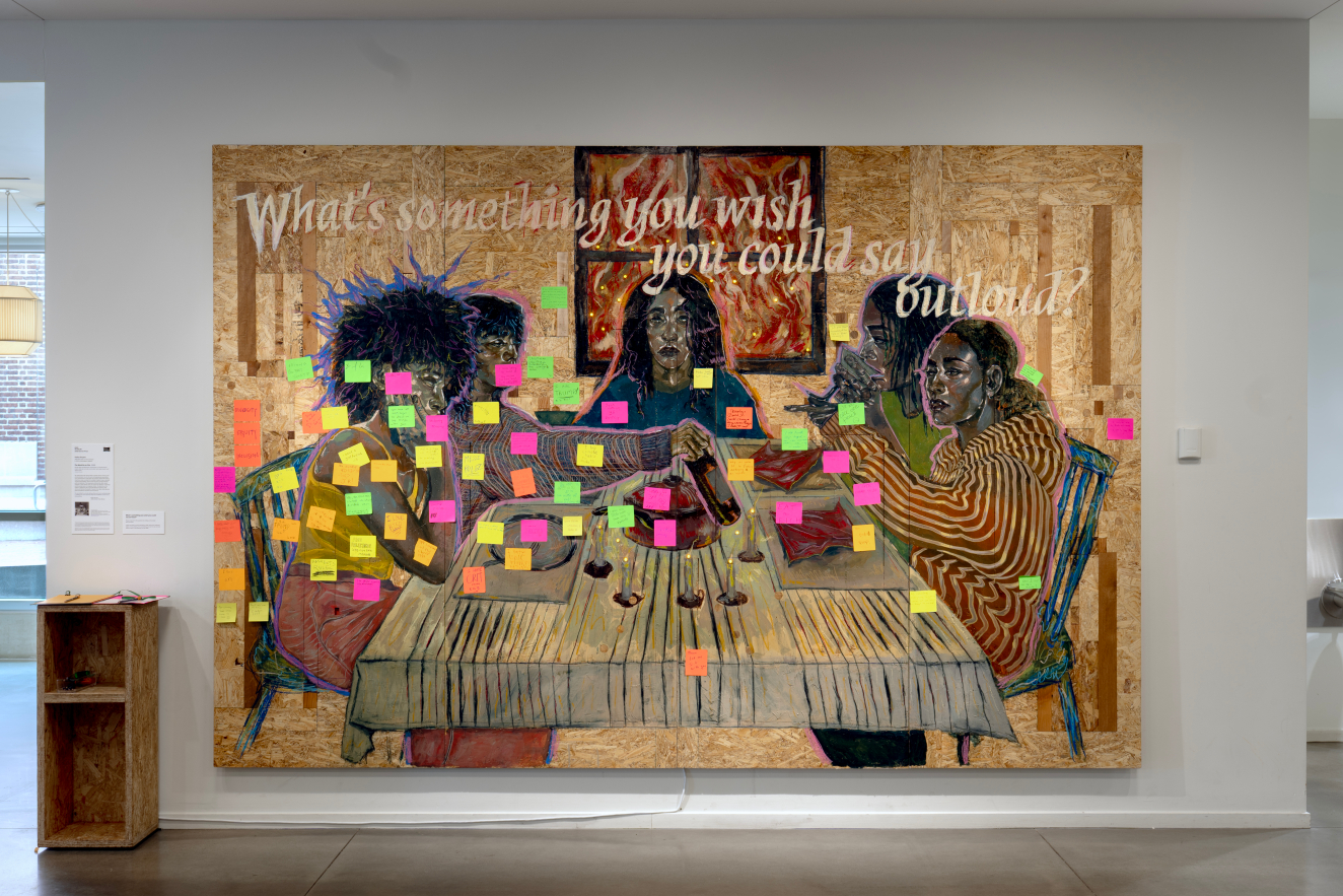 Large wall-sized painting in muted earthy tones features the question “What’s something you wish you could say outloud?” above five seated figures, covered below with bright sticky note responses. 