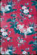 Segment of vintage wallpaper featuring a pattern of bright white swans within idyllic pond scenes. The vignettes are decorated with blue floral motifs on a deep red background.