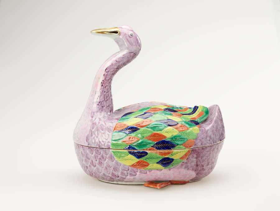 A sculptural vessel in the shape of a goose. The purple body is accented with diamond-shaped decorations in green, blue, yellow, and orange.