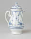 A white chocolate pot with delicate blue decorations with ribbed body, spout, handle, and foot.