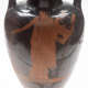 A close-up of a black ceramic vessel showing an orange depiction of a robed figure holding a stringed instrument, with visible cracks from age.