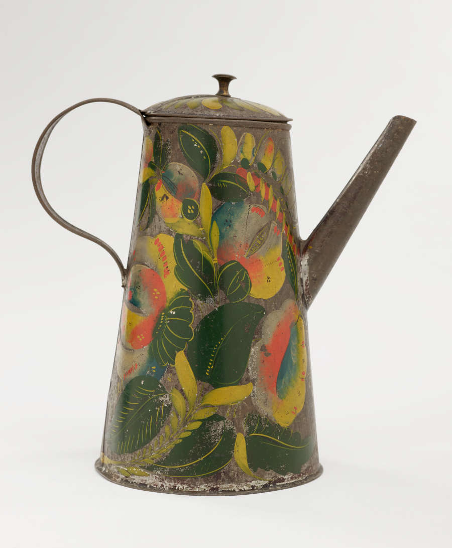 A tin coffee pot with painted orange, yellow, and green floral decorations.