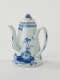 A white and blue teapot with floral decorations, a lid with a small semi spherical finial, spout, and a handle which is located approximately 90 degrees from the spout.