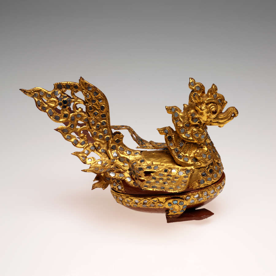 Connected top and bottom of a golden dragon-like bird container with embedded gems. The lid forms a dragon-like bird’s body, while the base is a cup-like stand.
