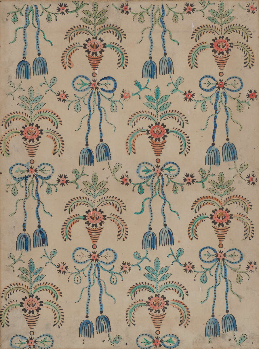 Segment of vintage wallpaper featuring a symmetrical repetitive pattern. The elegant print includes blue, pink, and green tassel motifs placed alongside floral designs; set on an off-white background.