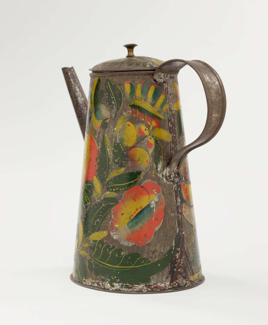 A tin coffee pot with painted orange, yellow, and green floral decorations.