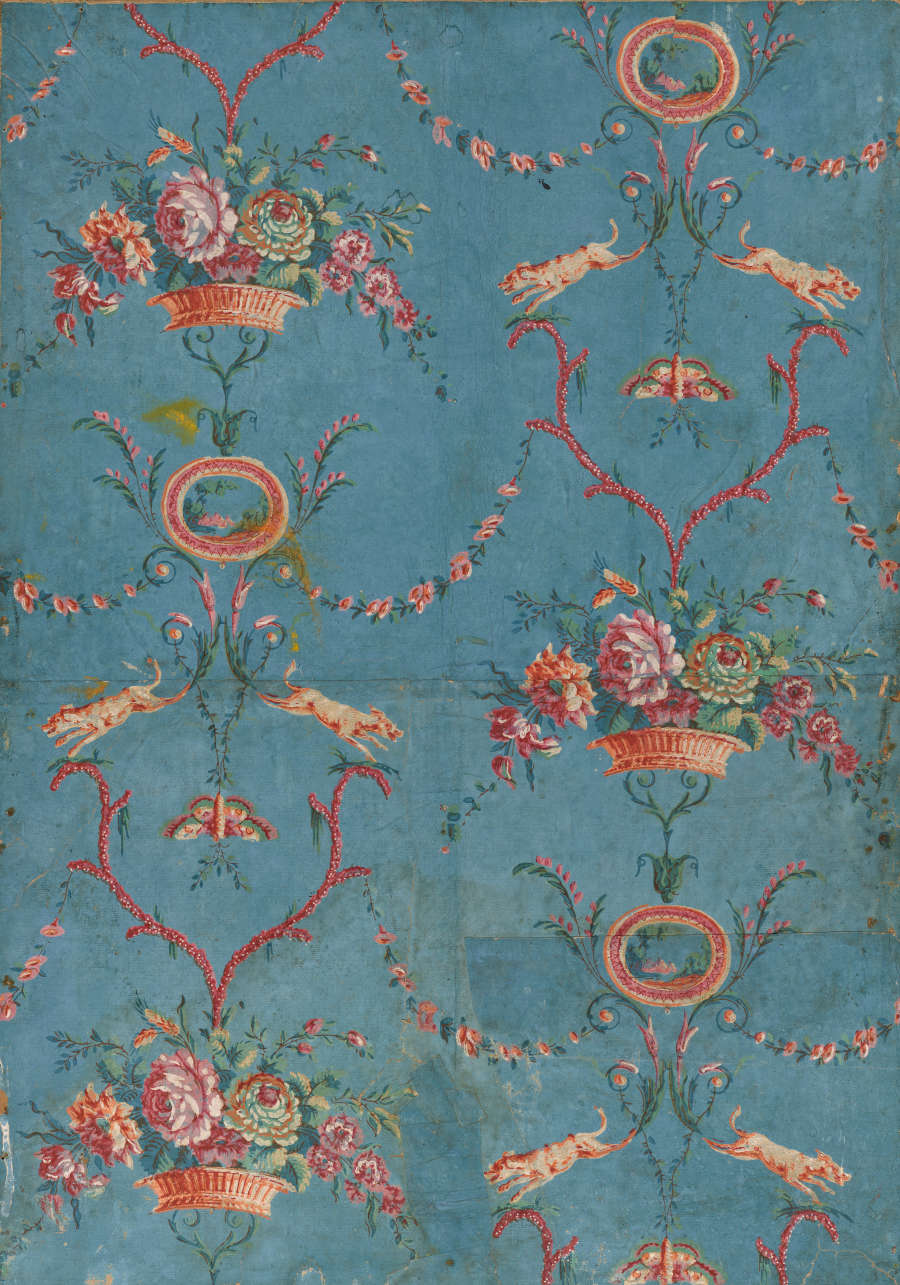 Segment of vintage repeating wallpaper featuring baskets filled with lush vibrant flowers and linking decorative garlands, on a faded and distressed blue canvas.