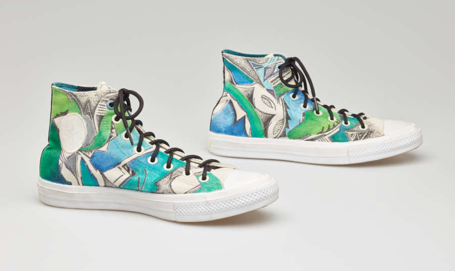 Stylish high-top sneakers with a tropical green and aqua pattern and black laces tied in a bow. The shoes are in pristine condition, with no signs of wear and tear.