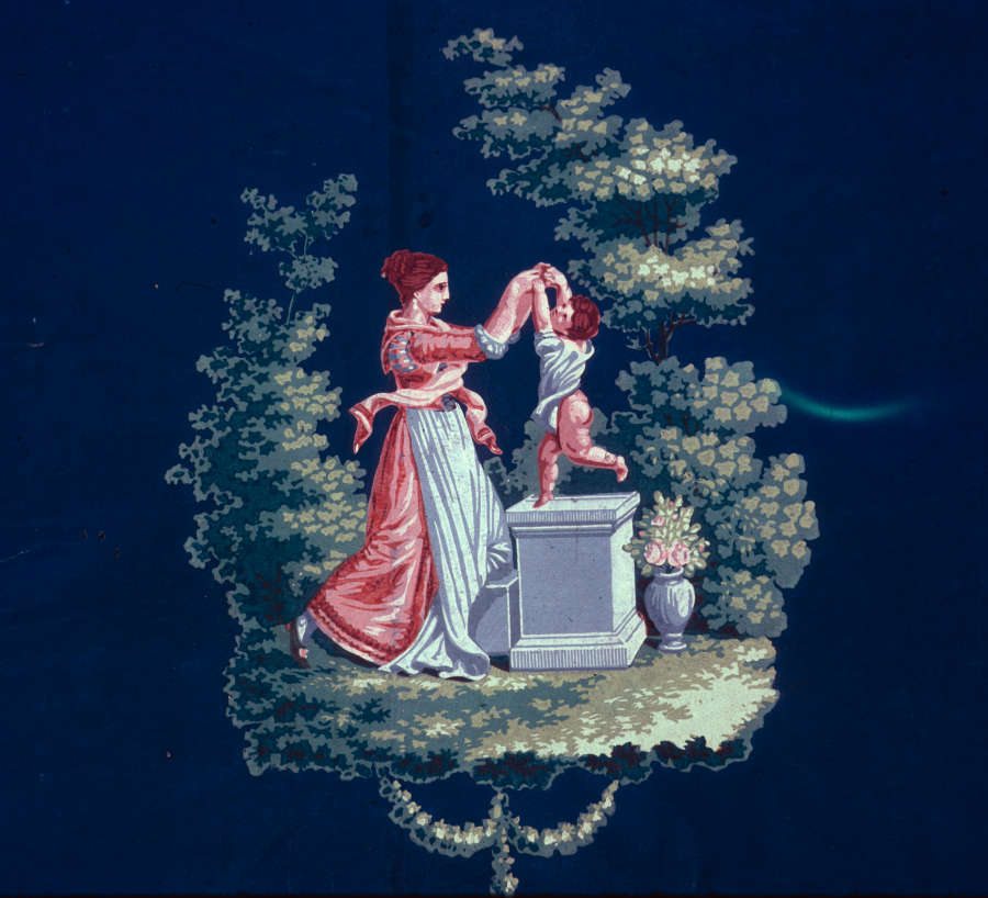 Fragment of a navy blue wallpaper depicting a garden scene of a lady in a red chiton dancing with a child standing on a white marble pedestal.