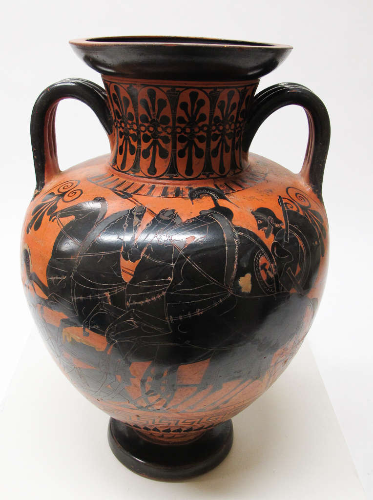 A terracotta vase with a black illustration of a chariot scene with horses and figures, bordered by ornamental borders and floral motifs. 