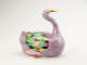 A sculptural vessel in the shape of a goose. The purple body is accented with diamond-shaped decorations in green, blue, yellow, and orange.