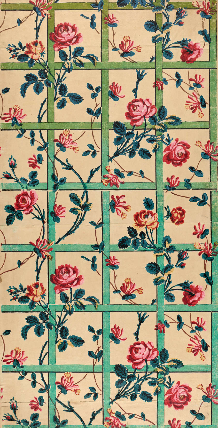 Panel of vintage wallpaper with a classic floral pattern featuring rows of roses in pink and orange hues, intersected by geometric green trellis designs on a pale yellow background.
