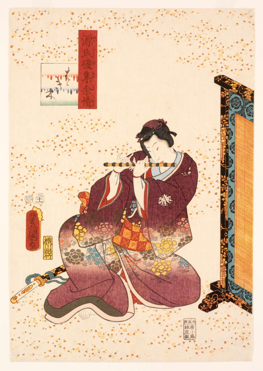 A richly embossed woodblock print with metallic embellishments. A seated man in a floral-patterned maroon robe plays the flute. A black lacquered screen is beside him.