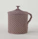 A purple covered cup with raised woven texture. The handle is sculptural and swirled.