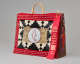 Rectangular leather and fur bag with red beaded border, central white circle with red-outlined seal silhouette, black geometric fur pattern, and red ribbon for 2nd place labeled “Artist Duplicate SW AIA 101st Annual Santa Fe Indian Market.”
