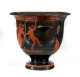 Black vessel with a wide top decorated with a scene of dancing figures, including a woman and a man with a goat tail framed by geometric designs in orange.